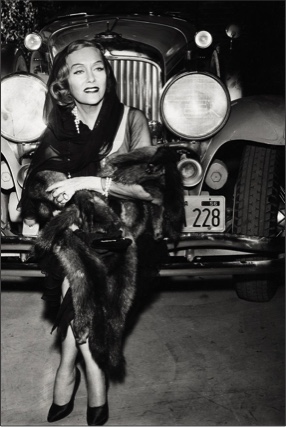 Gloria Swanson in front of classic car